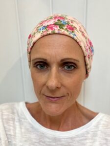 Dr Felicity Groom of The Grosvenor Practice wearing a headscarf, photographed during her own experience of cancer treatment.